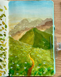 Painting of a mountain landscape in a notebook on a wooden surface