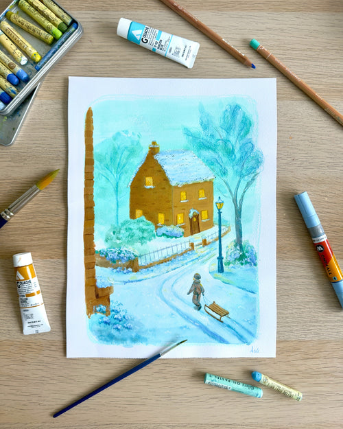 Winter scene painting on a wooden surface with art supplies